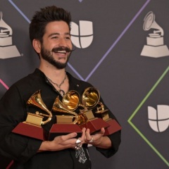 Colombian singer Camilo poses with his awards in the press room during the 22nd Annual Latin Grammy awards at the MGM Grand Arena in Las Vegas, Nevada, November 18, 2021. (Photo by Bridget BENNETT / AFP) (Photo by BRIDGET BENNETT/AFP via Getty Images)  (BRIDGET BENNETT / AFP via Getty Images)  Facebook Twitter